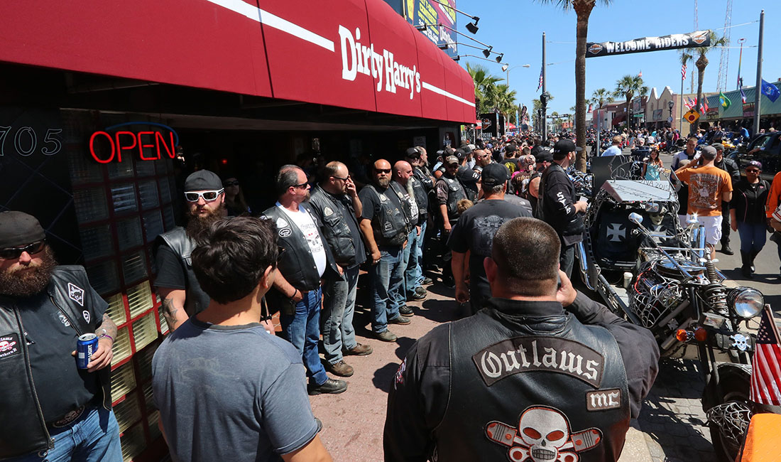 Daytona Beach Police keep an eye on  members of the Outlaws Motorcycle Club who showed up wearing their colors on Main Street in Daytona Beach Saturday March 18,  2017. [News-Journal/JIM TILLER ]