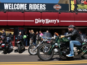 Biker pass Dirty Harry's bar on Main Street as bikers braved the cold temperatures during Bike Week Wednesday  March 15, 2017. [News-Journal/JIM TILLER ]