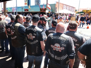 Members of the Outlaws Motorcycle Club stand shoulder to shoulder infront of Dirty Harry's bar on Main Street as Bike Week 2017 heads into it's last weekend in Daytona Beach Saturday March 18,  2017. [News-Journal/JIM TILLER ]